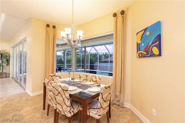 tiled dining room featuring a notable chandelier