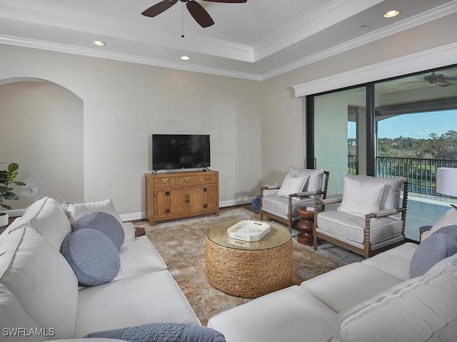 living room with ornamental molding and ceiling fan