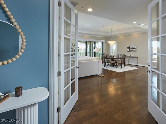 interior space with french doors, dark hardwood / wood-style floors, and a notable chandelier