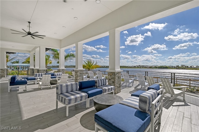 view of patio / terrace with an outdoor living space, a water view, and ceiling fan