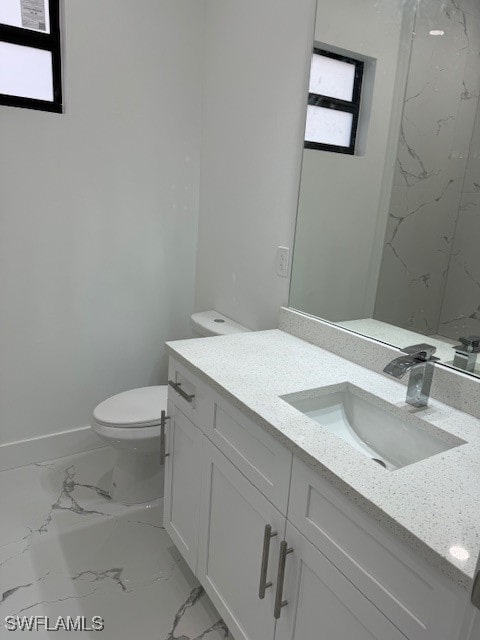 bathroom featuring toilet and vanity