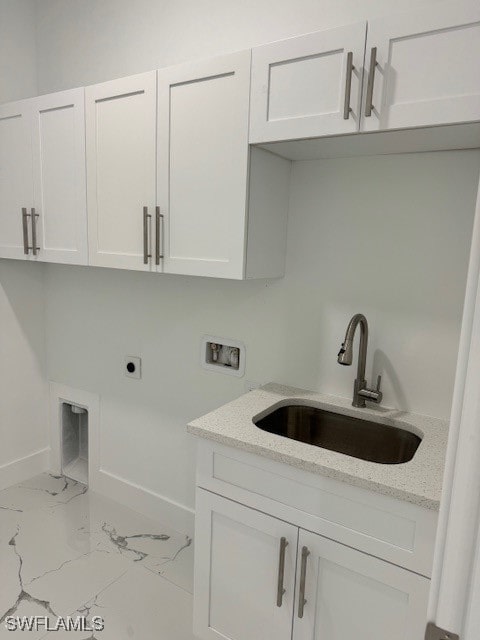 laundry area with electric dryer hookup, hookup for a washing machine, sink, and cabinets