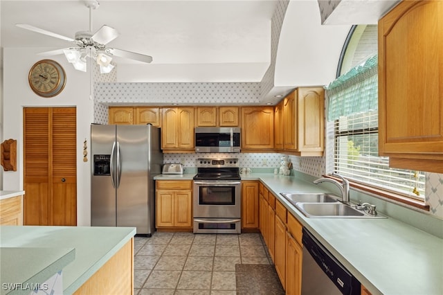 kitchen with sink, backsplash, ceiling fan, stainless steel appliances, and light tile patterned floors