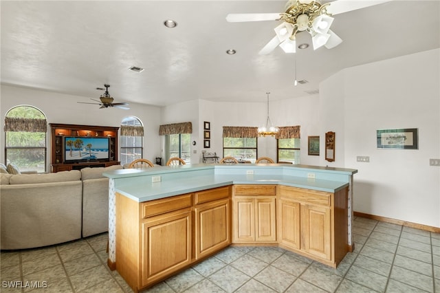 18351 Leetana Rd, North Fort Myers, FL 33917 - kitchen featuring open floor plan, a healthy amount of sunlight, light countertops, and ceiling fan with notable chandelier