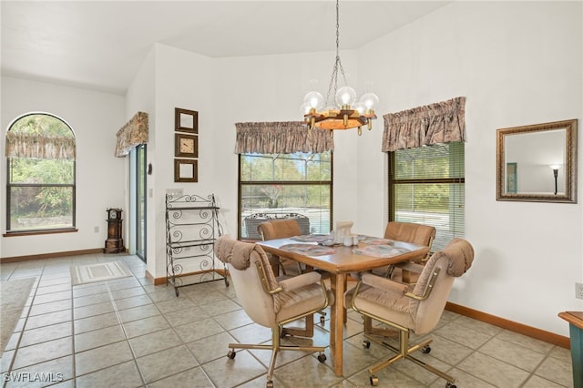 dining area featuring a notable chandelier, light tile patterned flooring, and vaulted ceiling