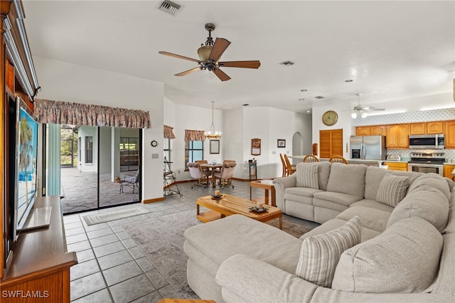 18351 Leetana Rd, North Fort Myers, FL 33917 - living room with light tile patterned floors, visible vents, and ceiling fan with notable chandelier