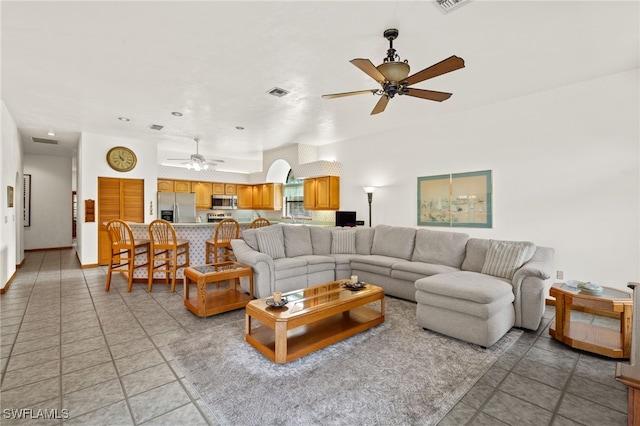 tiled living room featuring ceiling fan