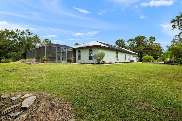 18351 Leetana Rd, North Fort Myers, FL 33917 - exterior space with a lawn, stucco siding, and glass enclosure