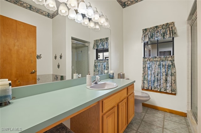 bathroom with vanity, toilet, tile patterned flooring, and an enclosed shower