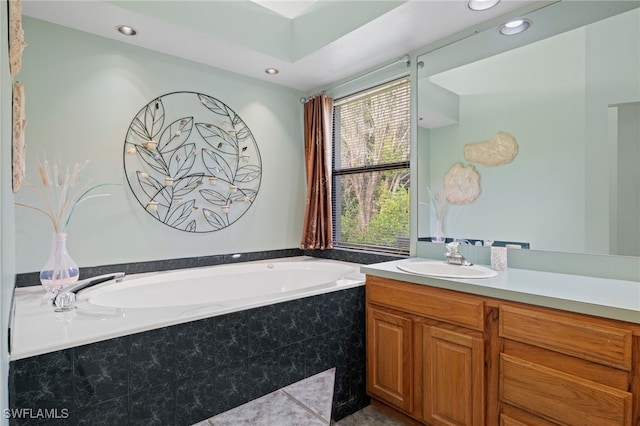 bathroom with vanity and tiled bath