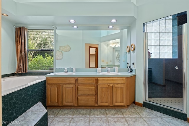 bathroom with vanity, separate shower and tub, a healthy amount of sunlight, and tile patterned floors