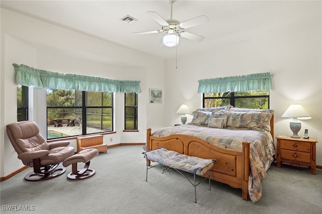 carpeted bedroom with multiple windows and ceiling fan