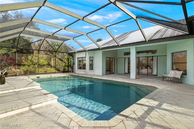 view of swimming pool featuring a patio and a lanai