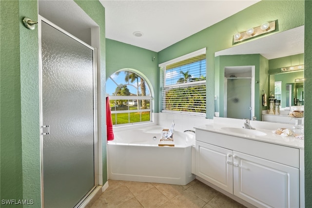 bathroom featuring shower with separate bathtub, tile patterned floors, and vanity