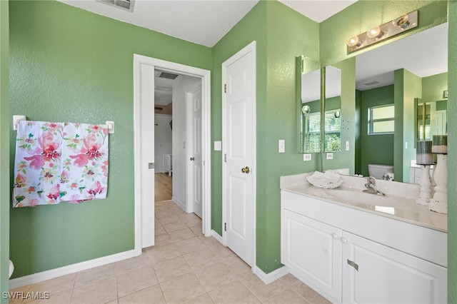 bathroom with vanity, tile patterned flooring, and toilet