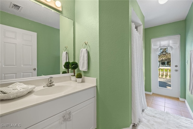 bathroom with vanity and tile patterned floors