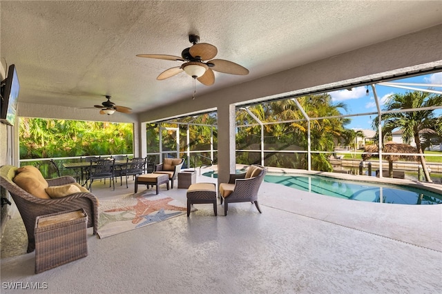 view of pool with a patio area, a lanai, and ceiling fan