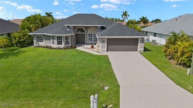 view of front of home with a front yard and a garage