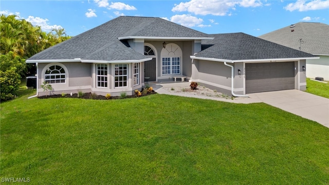 view of front of house featuring a front yard and a garage