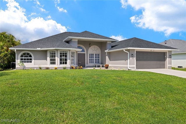 view of front facade with a front yard and a garage