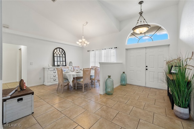 tiled foyer entrance with an inviting chandelier and high vaulted ceiling