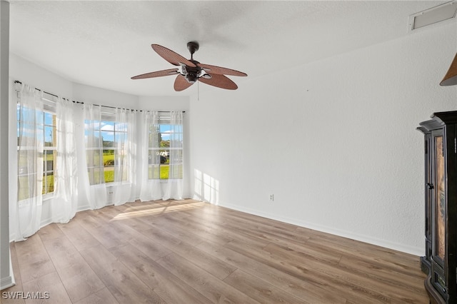 unfurnished living room with ceiling fan and hardwood / wood-style floors