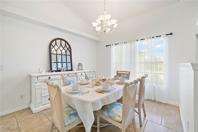 dining area with light tile patterned flooring, lofted ceiling, and a chandelier