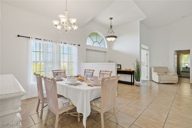 dining area featuring high vaulted ceiling, a wealth of natural light, an inviting chandelier, and light tile patterned floors