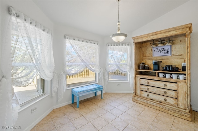 miscellaneous room with tile patterned flooring and vaulted ceiling