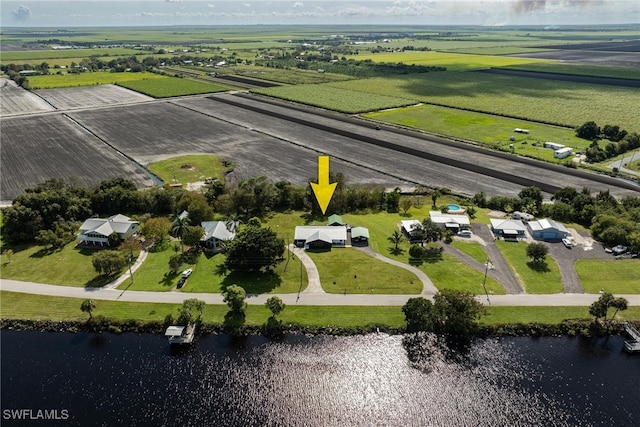 birds eye view of property with a water view and a rural view