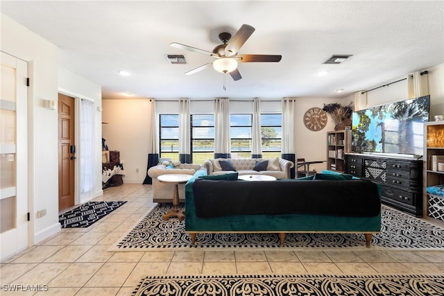 tiled living room featuring ceiling fan