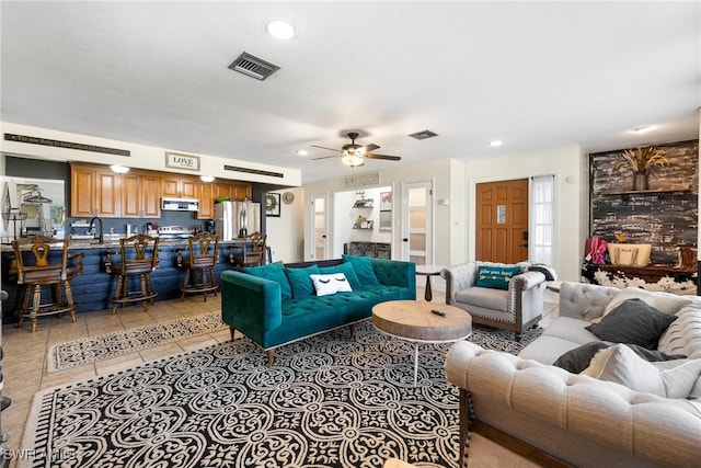 tiled living room with sink and ceiling fan