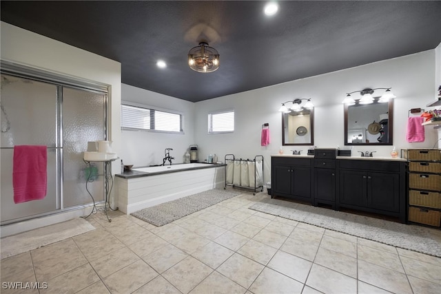 bathroom with vanity, independent shower and bath, vaulted ceiling, and tile patterned flooring