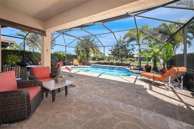 view of swimming pool with pool water feature, glass enclosure, and a patio area