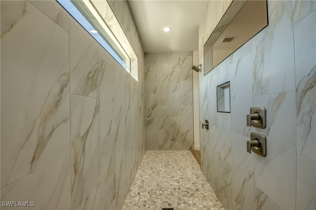 bathroom with tiled shower