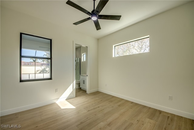 unfurnished bedroom featuring ceiling fan, light wood-type flooring, and ensuite bath