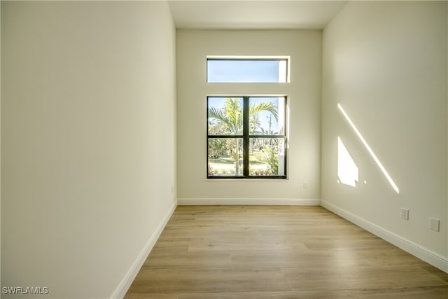 empty room with light hardwood / wood-style flooring