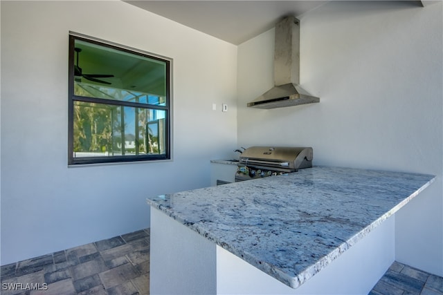 kitchen featuring kitchen peninsula, ventilation hood, and ceiling fan