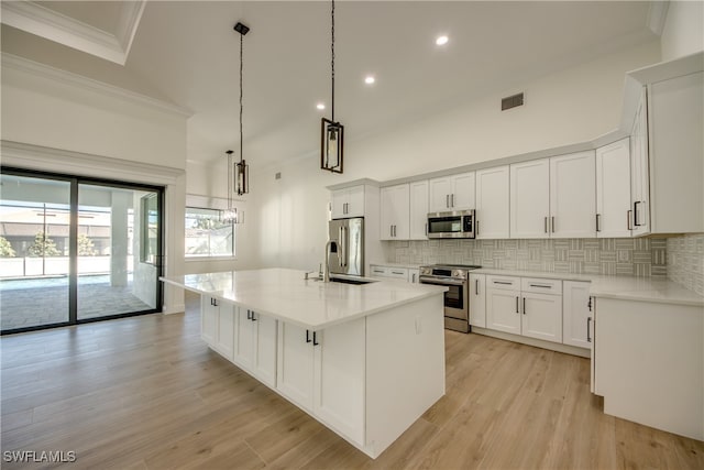 kitchen featuring an island with sink, white cabinets, appliances with stainless steel finishes, and sink