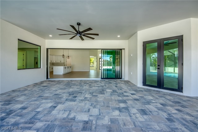 unfurnished living room with ceiling fan