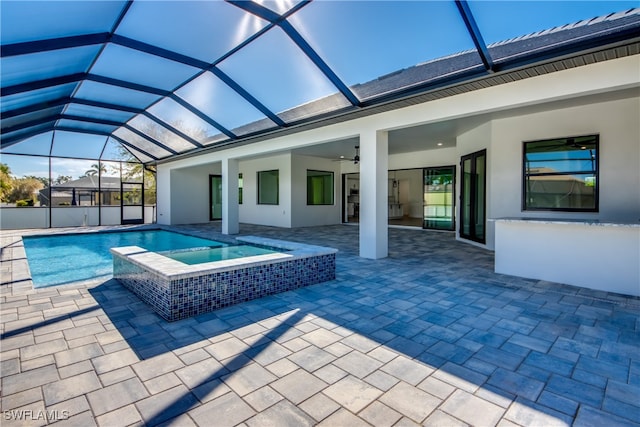 view of pool with ceiling fan, an in ground hot tub, a lanai, and a patio area