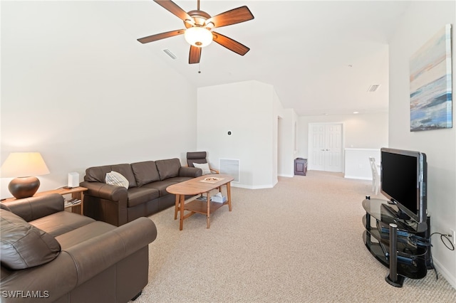 living room featuring light carpet, ceiling fan, and vaulted ceiling