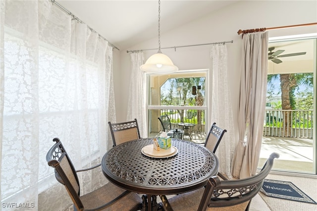 dining area with ceiling fan and vaulted ceiling