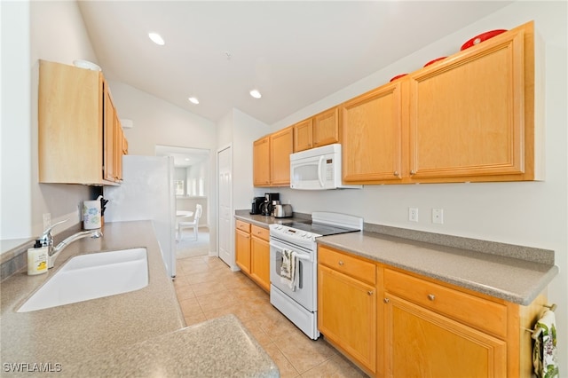 kitchen featuring light tile patterned flooring, lofted ceiling, sink, and white appliances