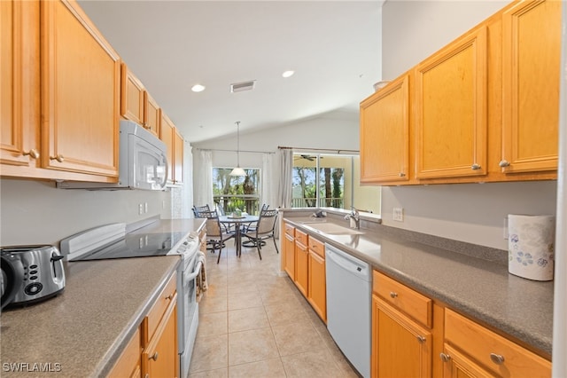 kitchen featuring white appliances, vaulted ceiling, sink, and light tile patterned floors