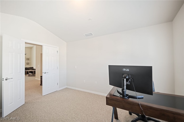 office area featuring vaulted ceiling and light colored carpet