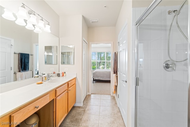 bathroom with walk in shower, vanity, and tile patterned flooring