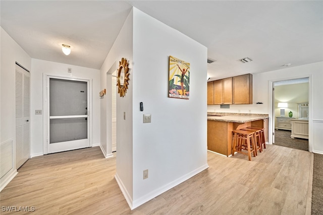 hall with light hardwood / wood-style flooring