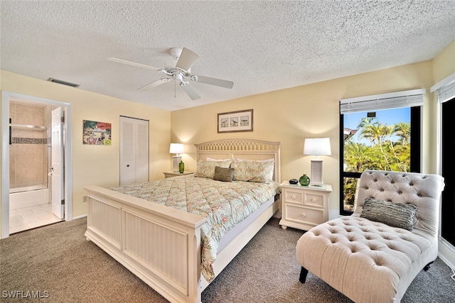 bedroom with ceiling fan, dark colored carpet, ensuite bath, and a closet