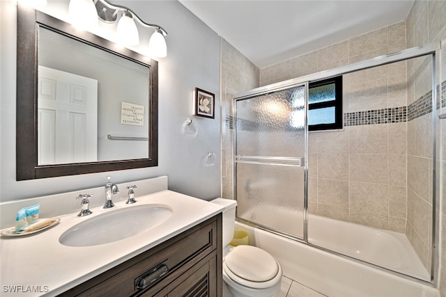 full bathroom featuring bath / shower combo with glass door, vanity, toilet, and tile patterned floors